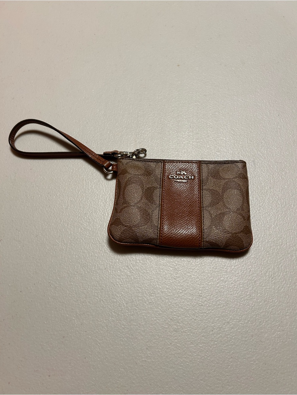COACH Signature Leather Wristlet in Brown Monogram.